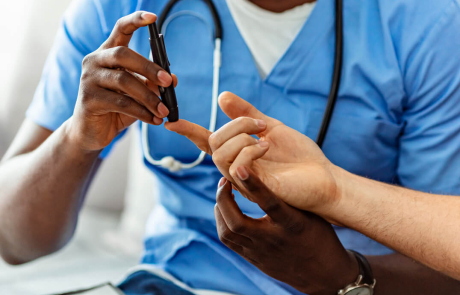 Blog T1D Diabetes Doctor Male Administering Blood Glucose Test