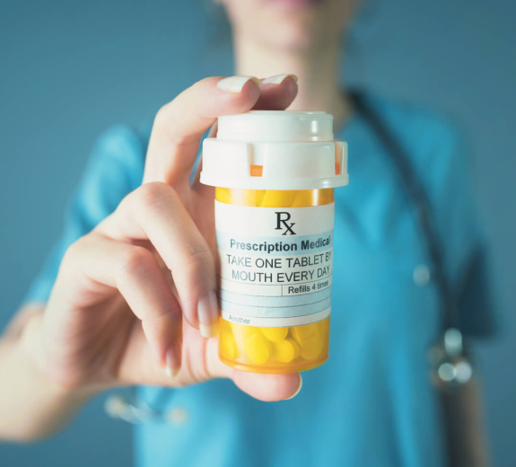 Blog Clinician Holding Prescription Drugs