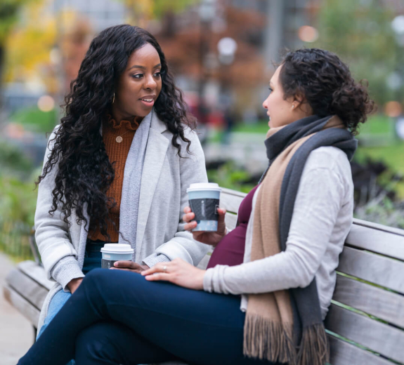 Blog Women Pregnant Talking Bench Outside